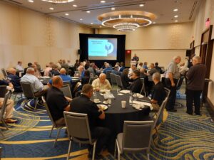 People sitting at tables at the Chairman's Lunch