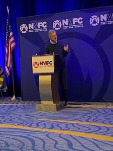 Dr. Richard Tedeschi delivering his presentation at podium