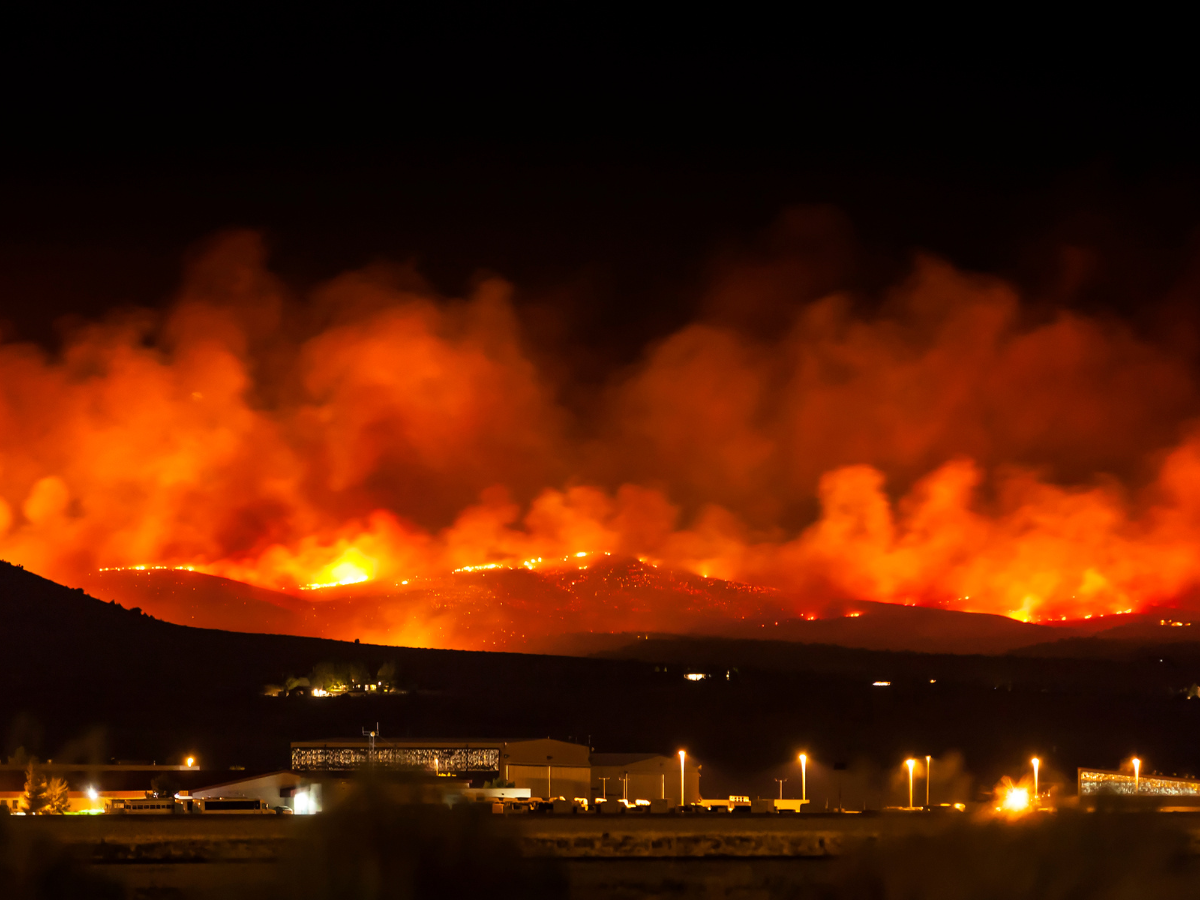 Wildfire smoke in hills behind city